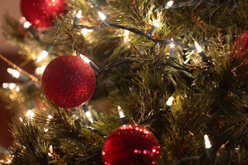 Close up of ornaments and lights on Christmas tree