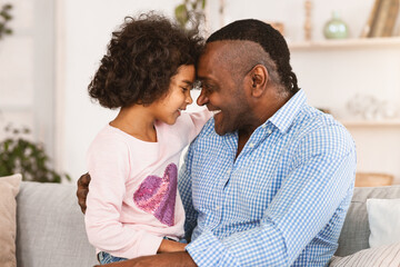 Fototapeta premium Love and friendship between generations. Cute girl with her granddad hugging each other at home