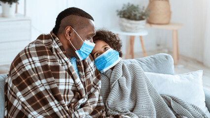 Virus spread danger. African american family staying at home, wearing protective masks, copy space....