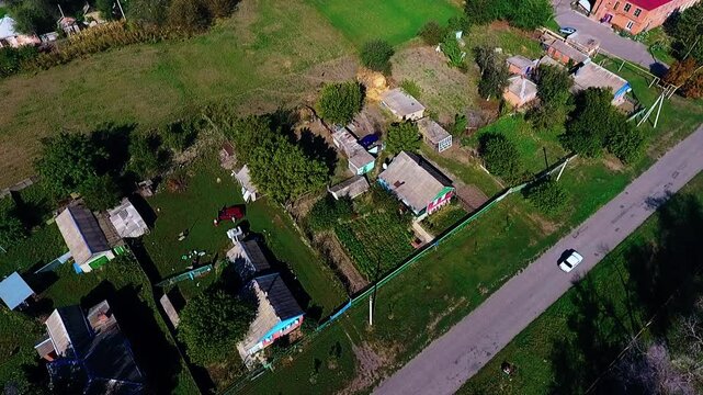 Summer day. Top-down wiew, capera shifting. Private houses with their own separate households.