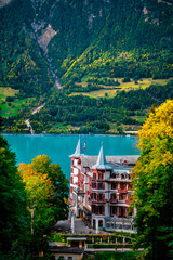 Majestic Lakeside Hotel Surrounded by Scenic Mountain Views and Lush Greenery in Serene Countryside Setting