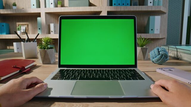 Student watching webinar green screen laptop at apartment workspace closeup. 
