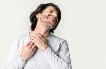 Eczema concept. Man suffers from skin irritation isolated on gray background