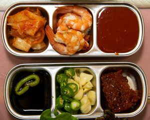 side dishes of sauces, vegetable and kimchi