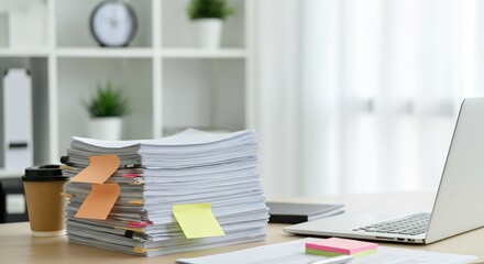 Neatly stacked documents with colorful sticky notes on busy office desk
