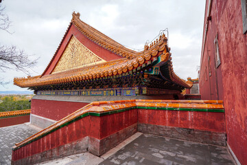Fototapeta premium Yellow Chinese glazed roof tile on Tibetan architecture in Summer Palace, Beijing