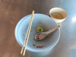 Emtry bowl of noodle after meal on stainless table