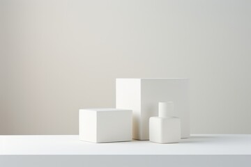minimalist composition of white geometric shapes on a clean surface