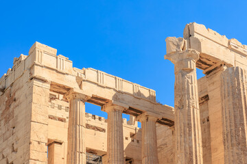 The building has a lot of columns and is very old, the Acropolis of Athens