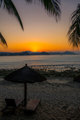 Beach daybed and the palm trees at Dadonghai beach, Sanya, China
