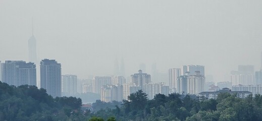 Fototapeta premium Skyscrapers fading into the mist of a hazy skyline.