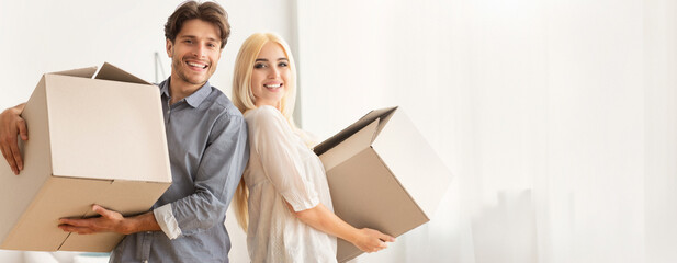 House Ownership And Relocation. Man And Woman Holding Moving Boxes Standing Back-To-Back Indoor, Copy Space