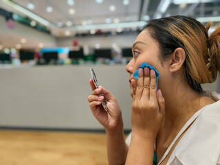 Look the makeup mirror asian woman using Facial oil clean film to removal oily on face