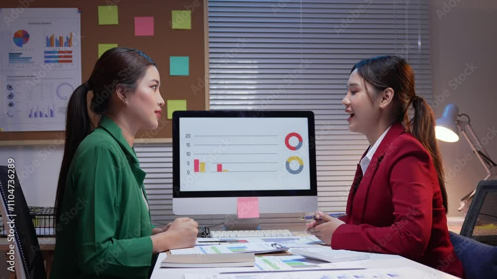 Poster two businesswomen are discussing over a computer with graphs and charts, ending with a handshake