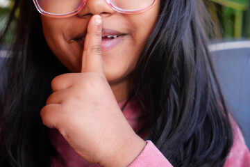  kid raising her hand indicating to stop talking or to be silent 