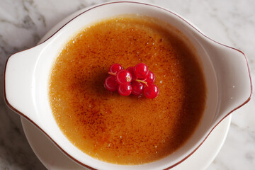  Caramel custard pudding on a plate on table 