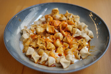 Traditional Turkish Manti Dumplings with Yogurt and Spicy Sauce