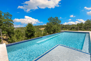 Serene infinity pool with stunning views of nature on a sunny day