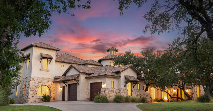 A stunning modern house showcases its unique architecture at sunset
