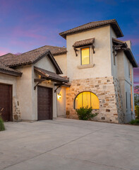 Beautiful sunset view of a charming rustic house with elegant architecture