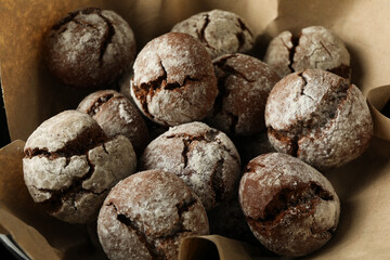 Delicious crinkle cookies in a plate, on a dark background.