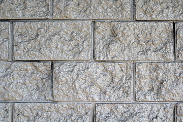 Grey gray block wall abstract textured background close-up