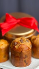 Traditional Italian panettone, mini Christmas cake. Classic Christmas handmade sourdough panettone and edible gift, on blurred background.