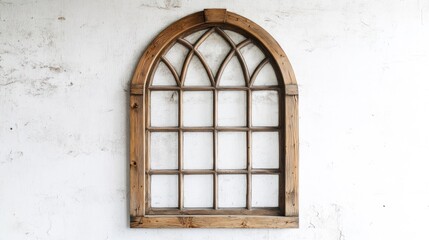 Fototapeta premium A decorative wooden window frame with an arched top against a textured wall.