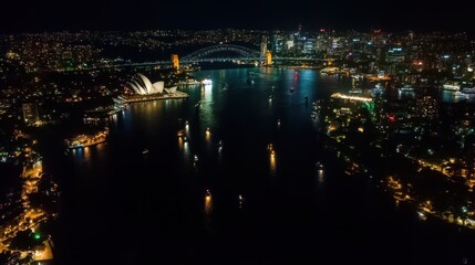 Naklejka premium A stunning night view of Sydney's harbor, showcasing the skyline and iconic landmarks.