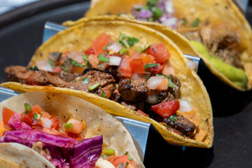 A plate of tacos with meat and vegetables