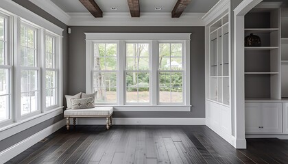 Fototapeta premium Sunroom with white windows, gray walls, dark wood floors, window seat, beamed ceiling, home decor style.