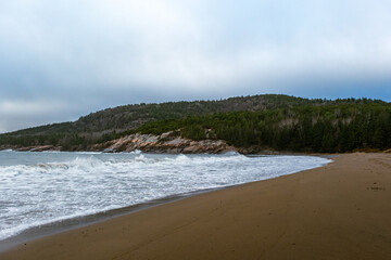coastal maine on foggy day acadia national park waves crashing on the beach pine forests on the atlantic ocean rocky coastal shores