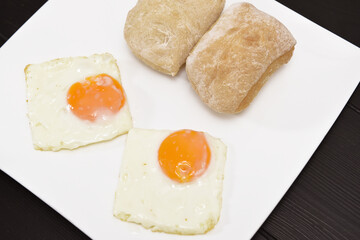 Fried egg with bread for breakfast on white plate