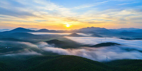 Fototapeta premium Aerial view of sprawling wind farm at sunrise, capturing serene beauty of mist covered hills and distant mountains