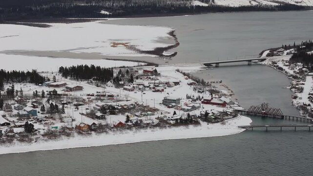 The Snow-covered Town of Carcross, Situated on the Shore of Bennett Lake, During Winter in the Yukon, Canada - Aerial Drone Shot