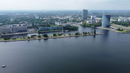 Modern office buildings of Riga with waving flag, aerial drone view