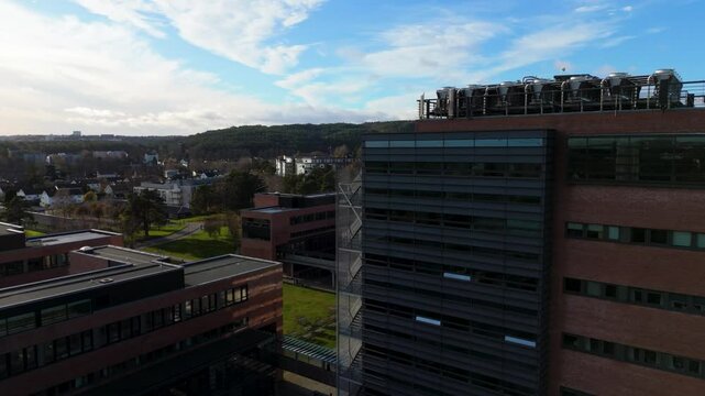 Modern architecture meets Scandinavian charm at the University of Agder, Kristiansand. Soaring aerial views capture the vibrant campus life and picturesque surroundings. Orbit with gimbal rotation 4k