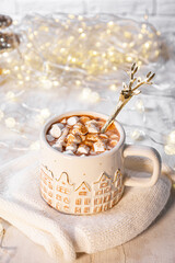 A mug of cocoa with marshmallows on a New Year's table on a white background. festive and cozy Christmas vertical card