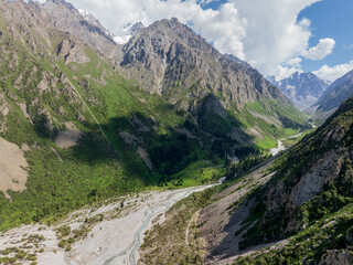 A mountain river, a stream meanders among the green slopes of the mountain. Summer landscape,...