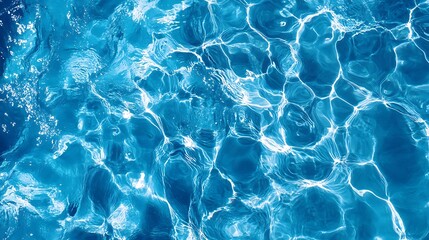 Bird's-eye view of blue water in a swimming pool with surface light reflections