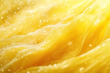 Abstract background of yellow fabric with soft, shimmering light.