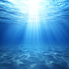Underwater scene with sunbeams illuminating ocean floor.