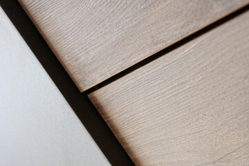 Close-up view of textured wooden boards with subtle color variations and clean lines in natural light. Photo