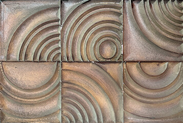 Abstract curved and spiral random cut decorative 3D panel board. 3D carved panel board  in random curvy pattern finished in bronze metallic brown decorative paint finish.