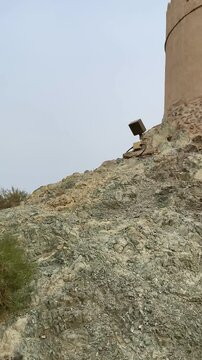 Stone staircase leads to traditional mud‑brick watchtower at historic Hatta Heritage Village, Dubai.