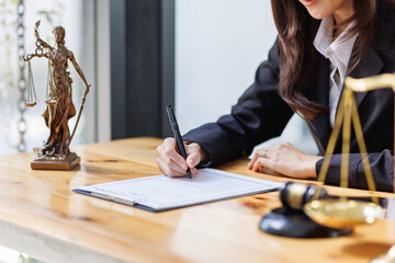 Lawyer business woman working with law book in office or courtroom Legal counsel with gavel and legal law. justice and lawyer concept Judge gavel hammer on Lawyer desk
