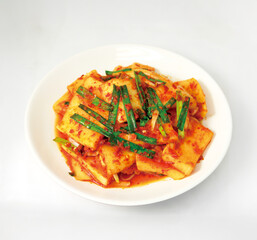 Traditional Korean Nabak Kimchi with Radish and Seasoning on a White Plate