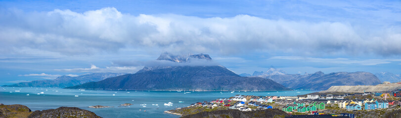 Typical architecture of Greenland capital Nuuk with colored houses located near fjords and icebergs. © eskystudio