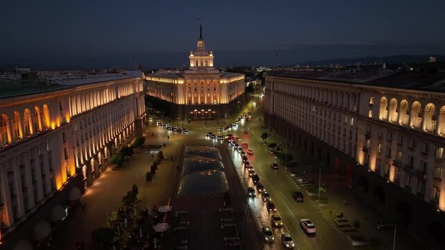 Aerial night view of capital of Bulgaria, Sofia. Three architectural and iconic buildings of the communist era. Council of Ministers, Presidency and Party Home, Current Parliament building. Backward