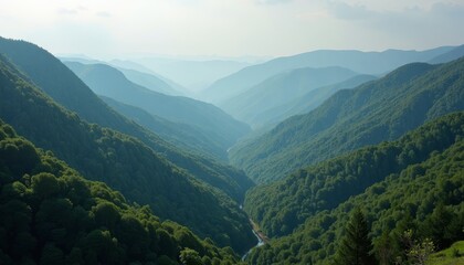Fototapeta premium Majestic green mountain valley with a river cutting through it